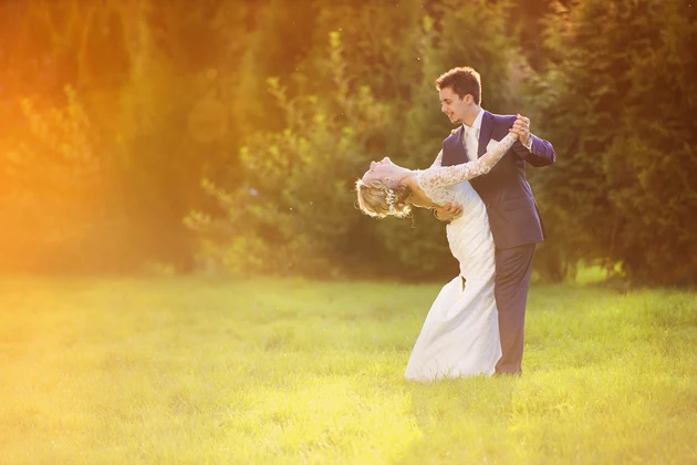 Young wedding couple on summer meadow